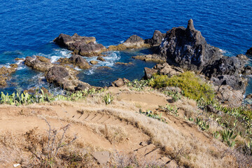 Natural volcanic pools with ocean water on the island of Madeira, Portugal. Stone stairs to the...