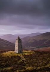 Stone Tower Amidst Rolling and Dramatic Skies