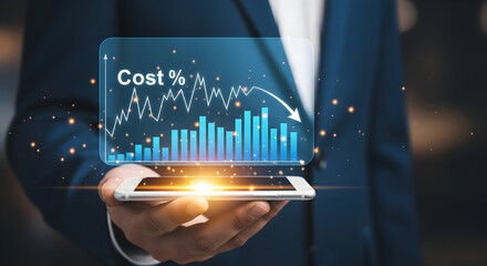 Businessman analyzes falling cost trends on futuristic digital interface displayed on smartphone