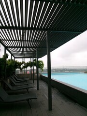 swimming pool chairs next to infinity pool