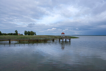 Scenic Wooden Pier on Calm Lake Under Cloudy Sky - Wieck a. Darß, Germany