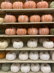 A retail display of decorative pumpkins of different colors for Fall festivals and Thanksgiving