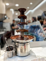 A tempting chocolate fountain with rich, dark chocolate flowing down its tiers