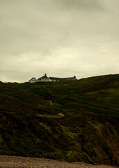 A house on a hill with a path leading up to it.