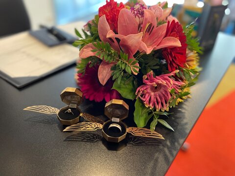 Wedding rings with a bouguet of roses