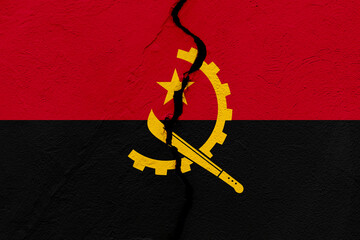 The flag of the Republic of Angola into a grunge cracked wall