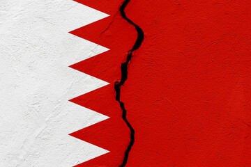 The flag of the Kingdom of Bahrain into a grunge cracked wall