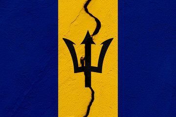 The flag of the Barbados into a grunge cracked wall