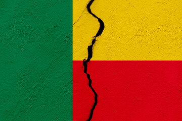 The flag of the Republic of Benin into a grunge cracked wall
