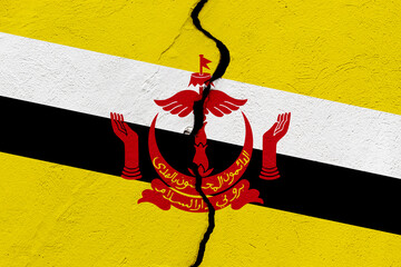 The flag of the Brunei Darussalam into a grunge cracked wall