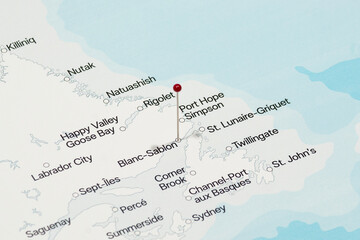 red pin needle into Blanc-Sablon city of Canada political map