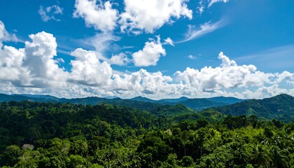 Naklejka premium Lush green mountains under a vibrant blue sky