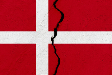 The flag of Denmark into a grunge cracked wall.