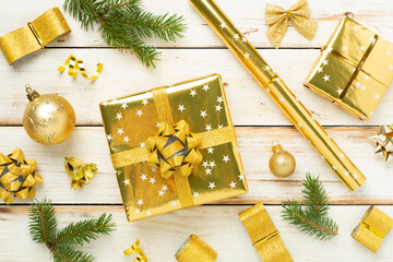 Handmade wrapped christmas gift boxes with stuff on wooden background, top view