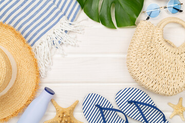 Blue beach accessories on wooden background, top view. Copy space for text