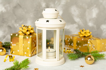 Beige christmas lantern with decorations on wooden table