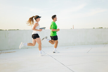 Energetic runners explore the rooftop track while enjoying a scenic urban backdrop during their...