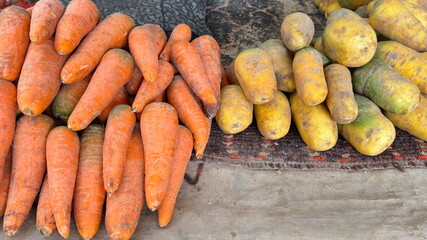 Bright orange and yellow carrots displayed in the market in Tashkent, Uzbekistan 