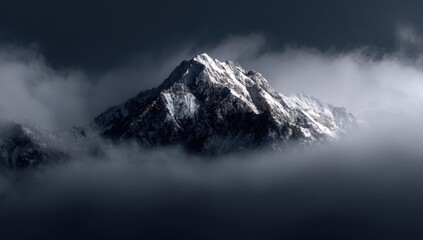 Snowy mountain peak piercing through a dense cloud layer