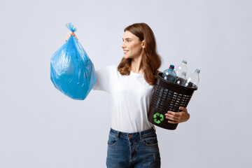 Waste Sorting. Positive Young Lady Holding Bag With Garbage And Bucket Filled With Plastic Bottles,...