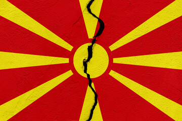 The flag of the Republic of North Macedonia into a grunge cracked wall