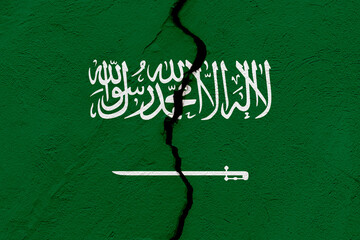 The flag of the Kingdom of Saudi Arabia into a grunge cracked wall