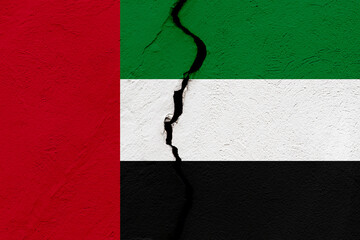 The flag of the United Arab Emirates into a grunge cracked wall