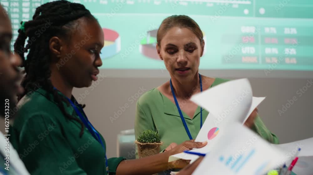 Poster close up of diverse staff hand over data projections papers in a meeting after hours for multination