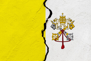 The flag of the Vatican City State into a grunge cracked wall