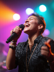 Passionate singer performing on stage, bathed in colorful lights. Represents music, talent, expression, and live performance. Suitable for entertainment or art.