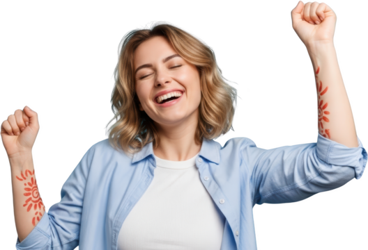 Woman with eyes closed laughing with fists raised and patterned tattoos on arms