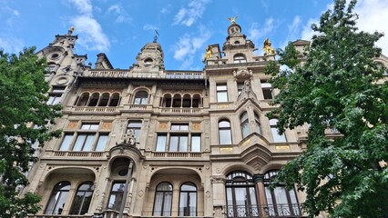 Obraz premium Historic European Facade with Sculptures and Golden Statues in Antwerp, Belgium