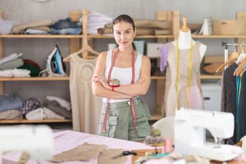 Woman fashion designer is in office seamstress workshop studio. Production of clothes according to individual measurements, manual piece manufacturing,