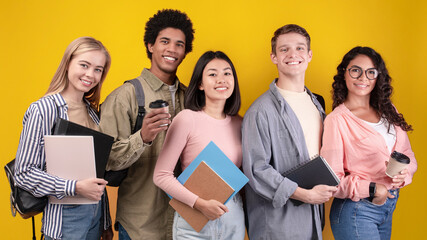 Knowledge sharing between people and modern study. Smiling young multi ethnic students with...