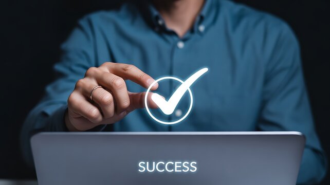 Person touching glowing checkmark in circle with SUCES text on laptop image photo