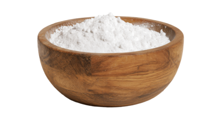 a wooden bowl filled with white powder on a white background