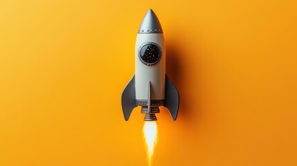 Small gray and black rocket model launching with fire and smoke on bright orange background symbolizing space travel and innovation