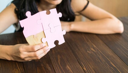 girl's hands holding a pile of messy puzzles