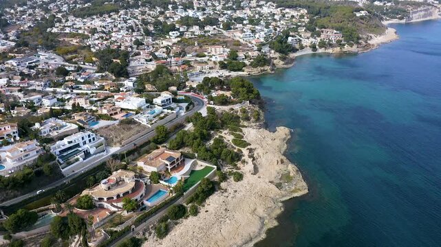 Aerial view of the little beach of Cala Fustera, Cala Llobella, Cala del Advocat in Benissa coast, Mediterranean Sea, Spain.