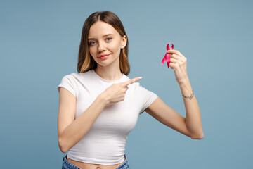 Woman showing pink ribbon supporting breast cancer awareness