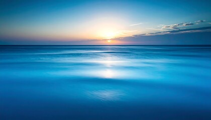 Obraz premium Peaceful sunset over a still ocean