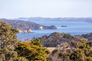 Scenic view of the Mahurangi Harbour, New Zealand, showcasing the lush green islands and clear blue...