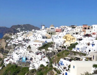 Panoramic view of a picturesque, white-washed village nestled on a hillside overlooking the sea