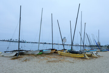 Catamarans and other vessels on a sand of boat beaching area of Sail bay, San Diego, California