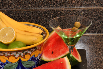 This vibrant still-life photograph features a ruby-red martini in a classic conical glass,...