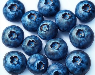 Close-up view of fresh ripe blueberries with textured skin and small blossom crowns, showcasing natural blue hues and smooth surface under bright lighting