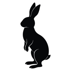 Fototapeta premium Black silhouette of a rabbit standing on hind legs with ears upright bunny hare