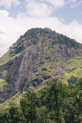 Obraz premium Green vegetation and trees covering the steep slopes of Little Adam's Peak, a popular tourist attraction near Ella, Sri Lanka