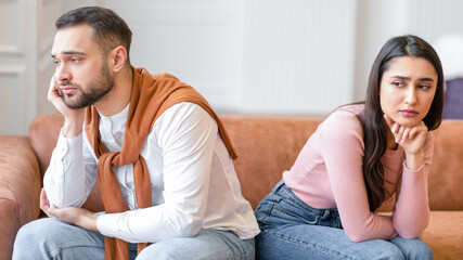 Marital Problems. Unhappy Arab Couple Sitting Back-To-Back Not Talking After Quarrel On Couch At...