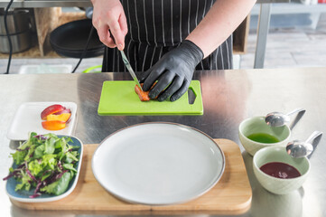 The chef slices the roast duck. 